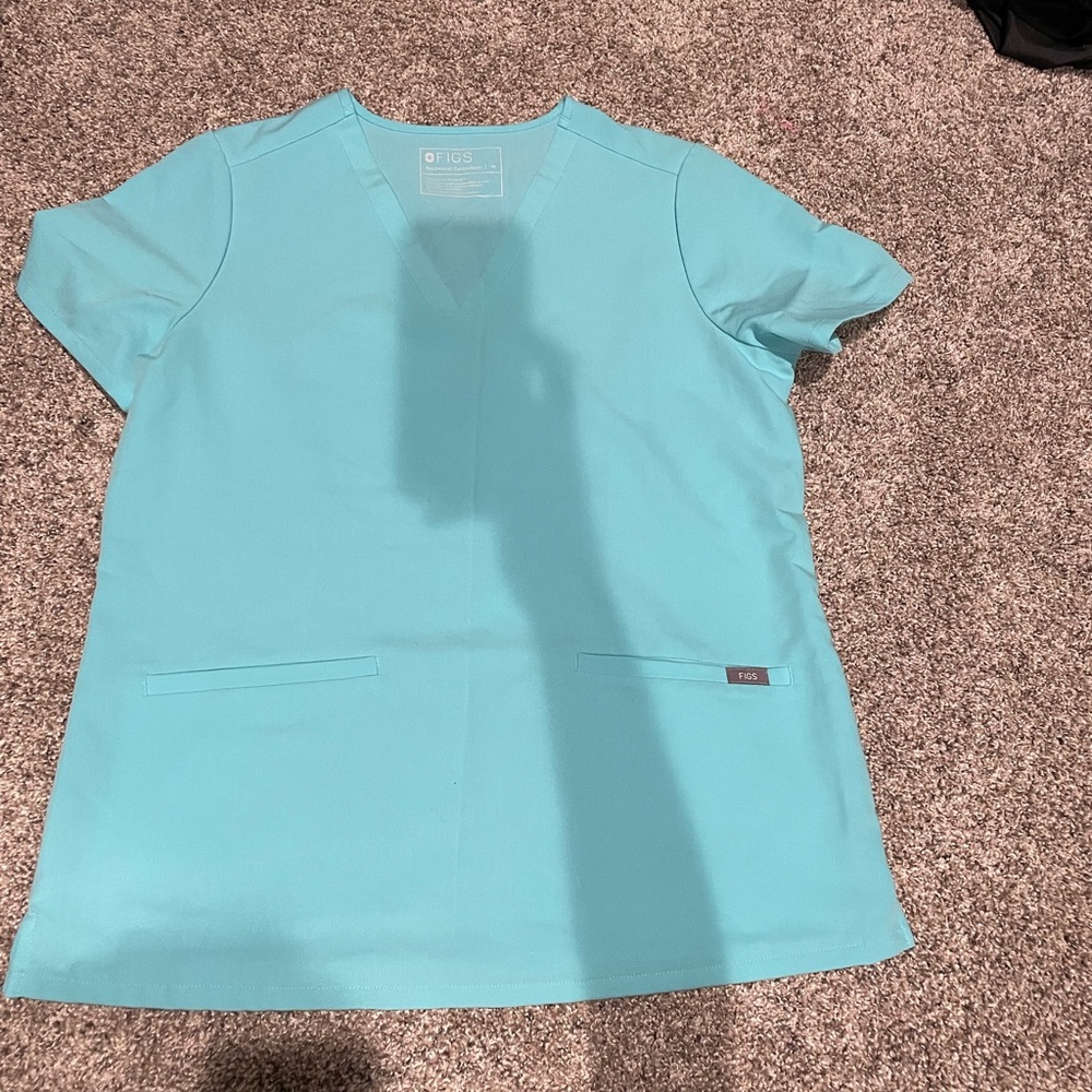 Neon blue medium three pocket figs top. Perfect condition never wore.